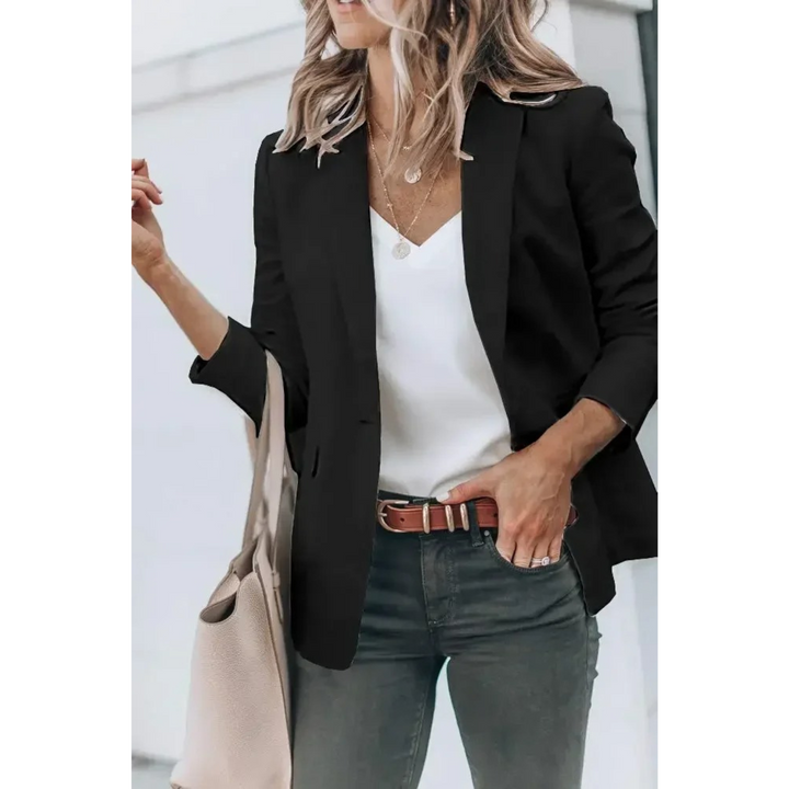 Woman wearing black plain blazer with puff sleeves paired with jeans