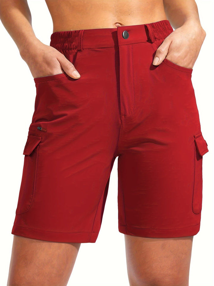 Woman wearing vibrant red outdoor cargo shorts with stretch fabric