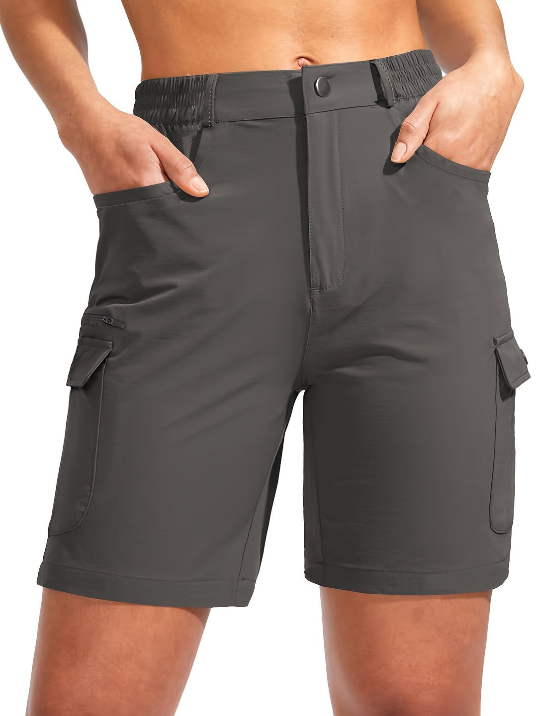 Woman wearing dark gray quick-dry cargo hiking shorts with multiple pockets