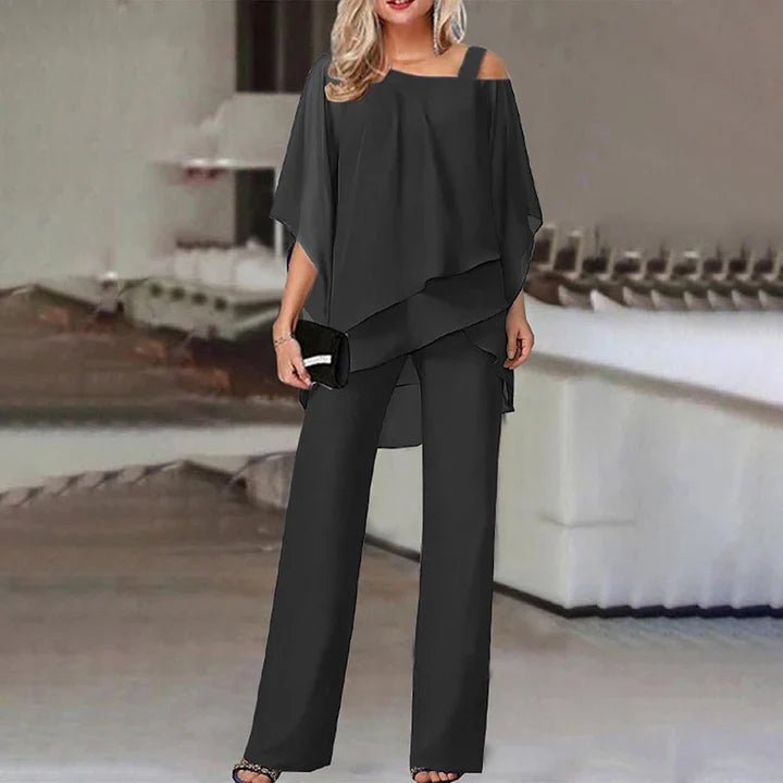 Model wearing the black elegant layered two-piece co-ord set with a handbag