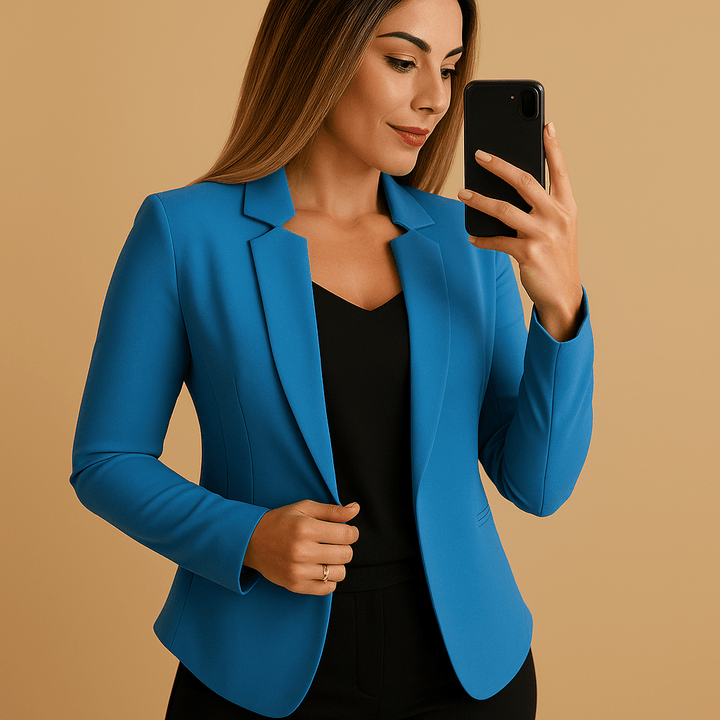A woman wearing a blue lightweight blazer and smiling