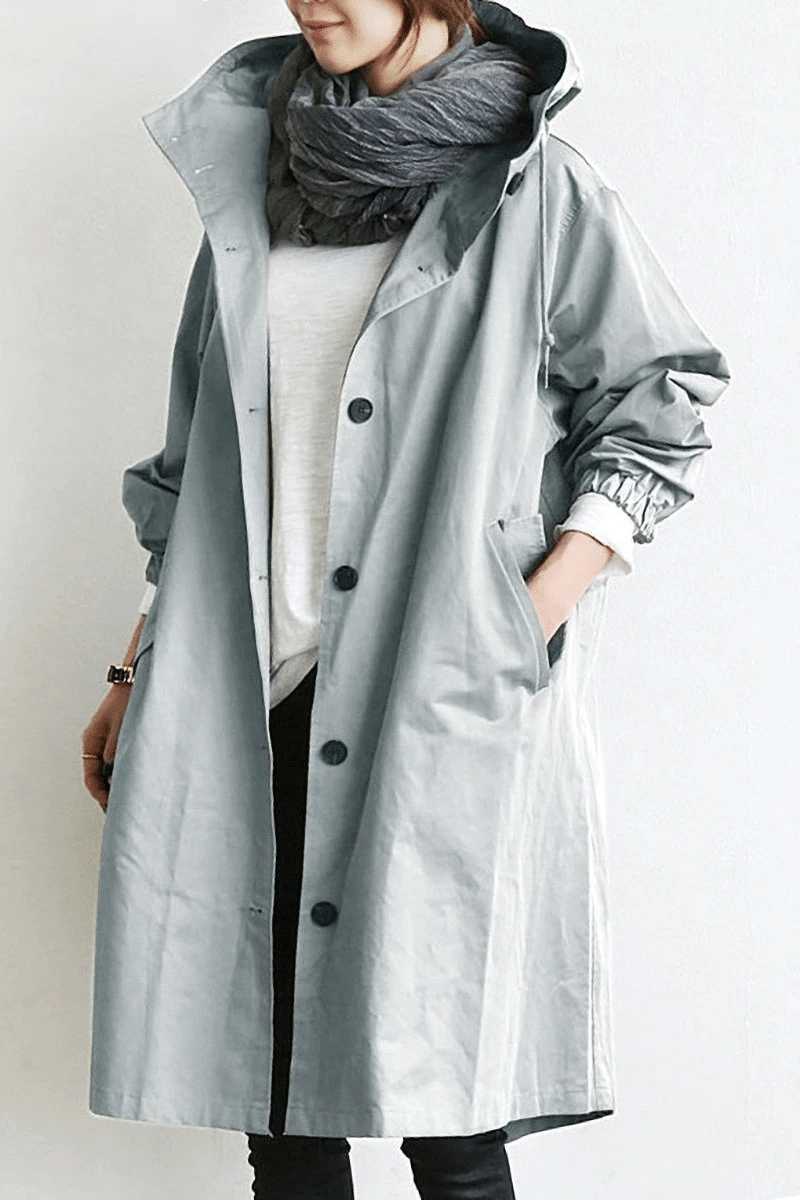 Close-up of the light grey Aurora windbreaker with hood and pockets