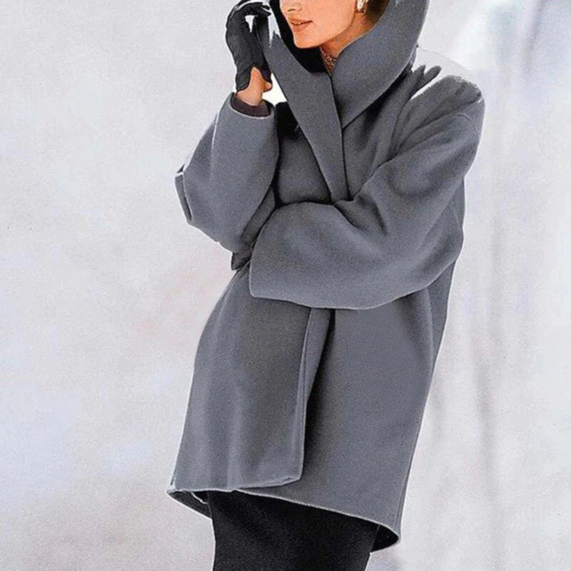 Woman wearing a gray stylish winter jacket with a hooded collar design