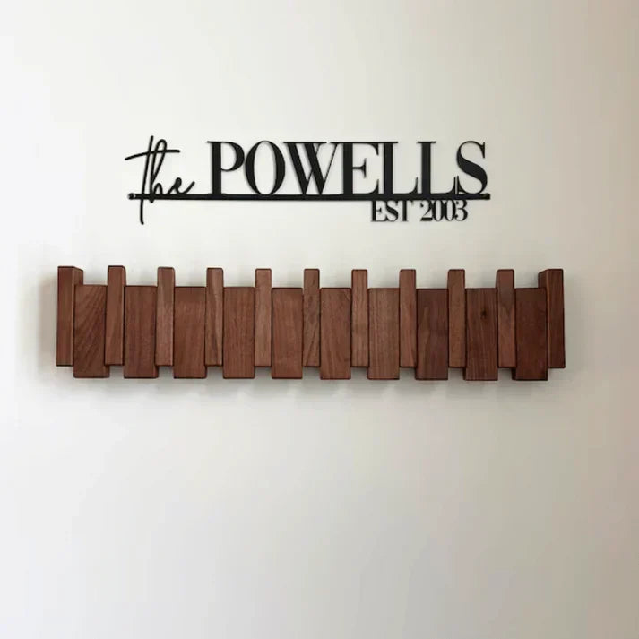 Close-up of wooden piano wall hook showing foldable keys and grain detail