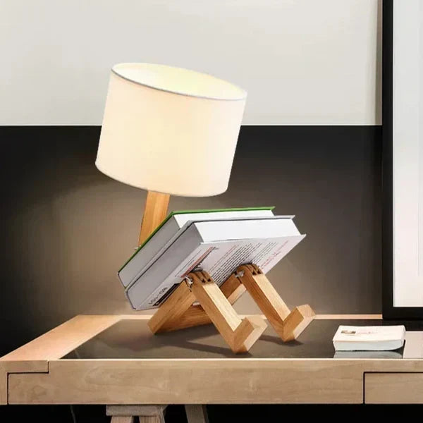 Decorative wooden robot reading light glowing softly in a cozy bedroom