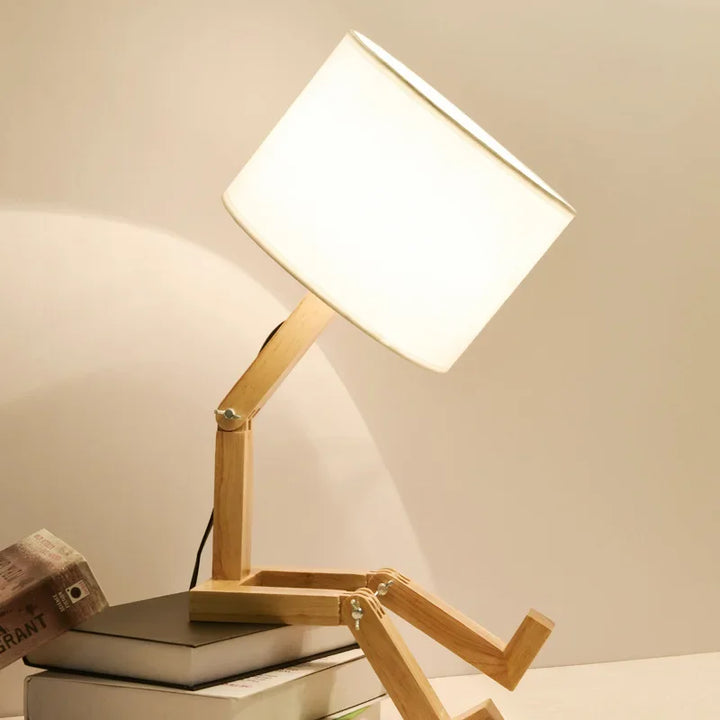 Modern bedside lighting setup featuring the adjustable wooden robot lamp
