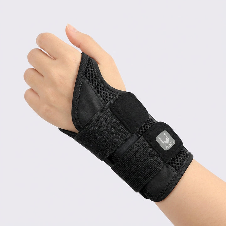 Close-up of black half finger wrist support brace worn on the right hand